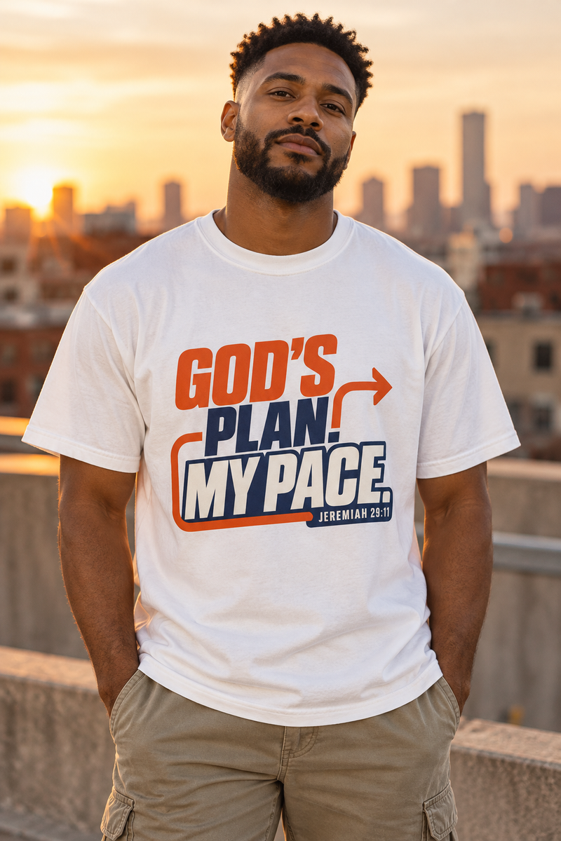 Black model wearing the 7Fold gods plan shirt, front print visible in warm urban rooftop setting