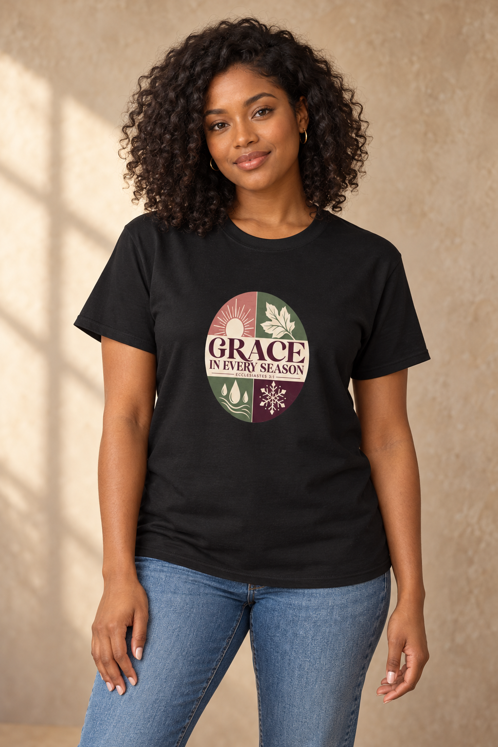 Black woman wearing the black 7Fold Grace in Every Season tee with four-season front artwork