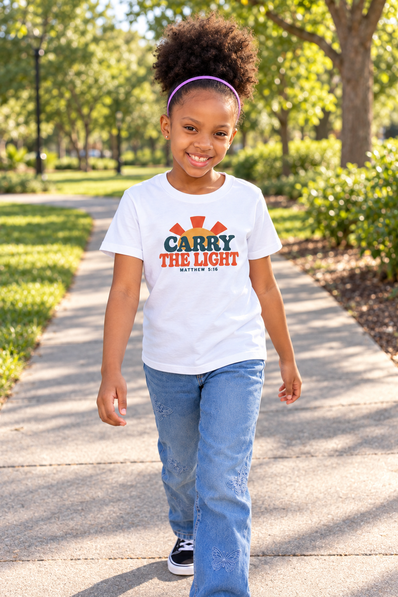 Child walking in a white Carry the Light 7Fold kids tee